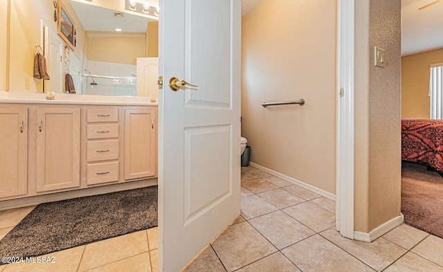 bathroom featuring tile patterned flooring, toilet, and walk in shower