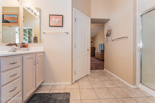 bathroom featuring tile patterned floors, vanity, and a shower with shower door