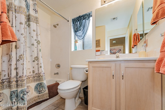 full bathroom featuring tile patterned floors, vanity, toilet, and shower / tub combo with curtain