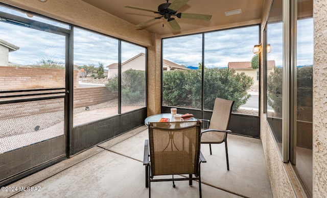 sunroom / solarium featuring ceiling fan