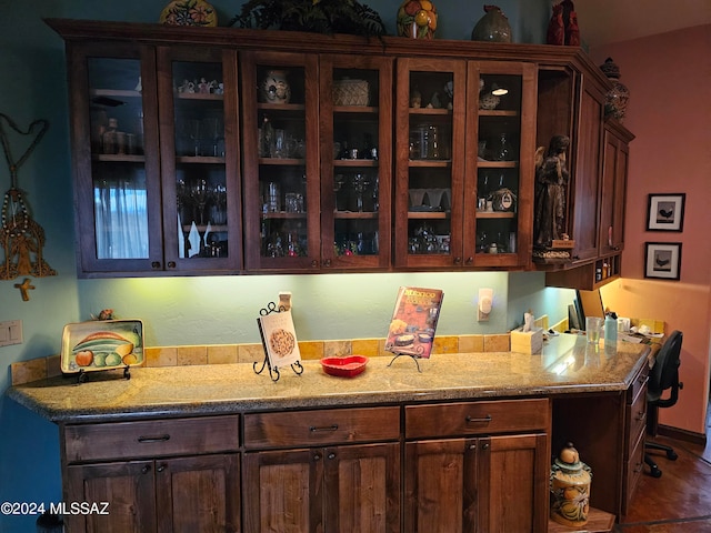 kitchen with dark brown cabinetry and light stone counters