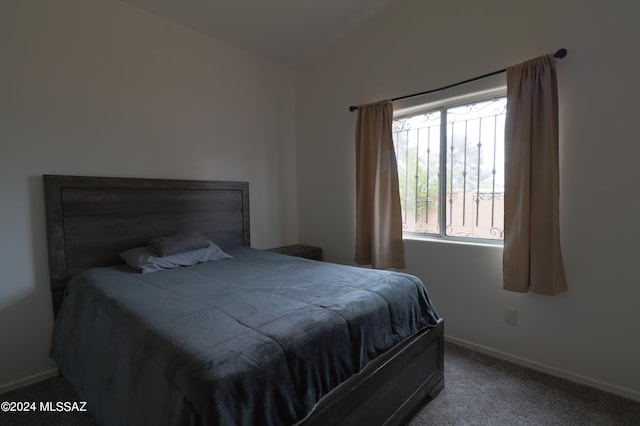 bedroom featuring carpet flooring and lofted ceiling