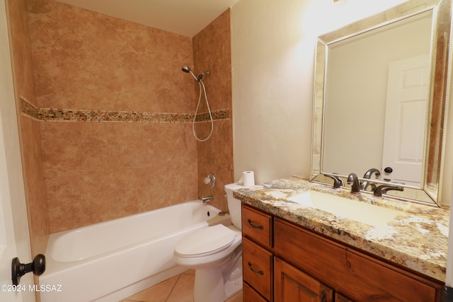 full bathroom featuring toilet, vanity with extensive cabinet space, tile flooring, and tiled shower / bath combo