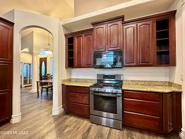 464 N 1st Ave, Thatcher, AZ 85552 - kitchen featuring light stone countertops, light wood-type flooring, stainless steel range with gas cooktop, and decorative columns