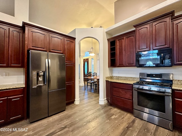 464 N 1st Ave, Thatcher, AZ 85552 - kitchen featuring light stone countertops, appliances with stainless steel finishes, a towering ceiling, and wood-type flooring