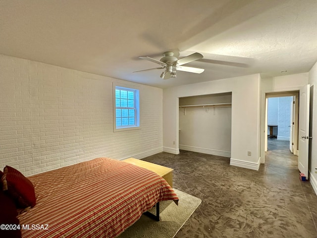 464 N 1st Ave, Thatcher, AZ 85552 - bedroom with a textured ceiling, a closet, ceiling fan, and brick wall