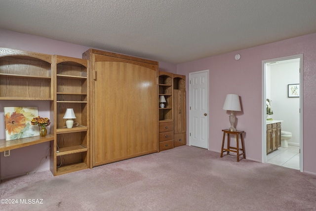 interior space featuring a textured ceiling and light carpet