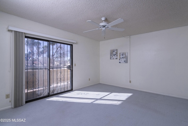 spare room with a textured ceiling, ceiling fan, and carpet