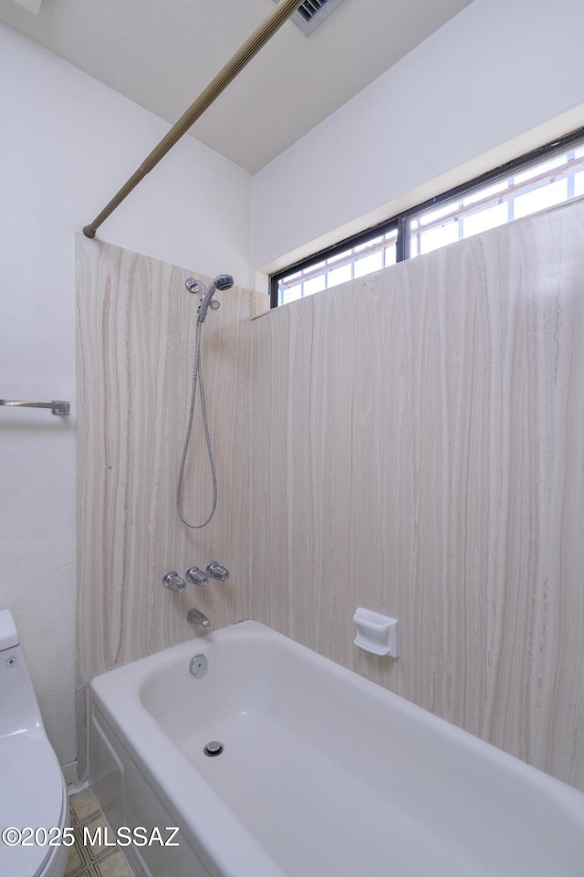 bathroom with shower / tub combination and toilet