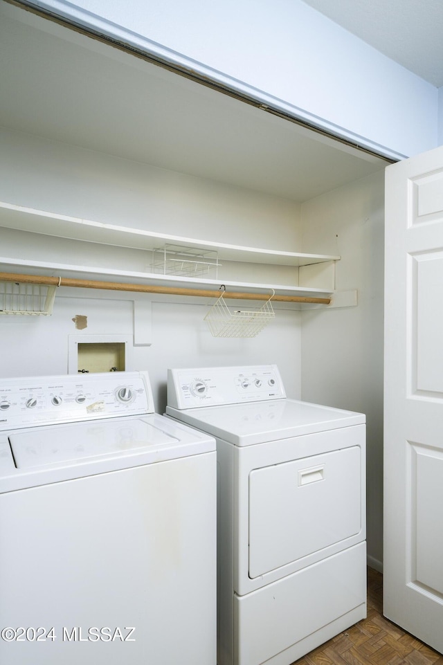 washroom featuring washer and clothes dryer and parquet flooring