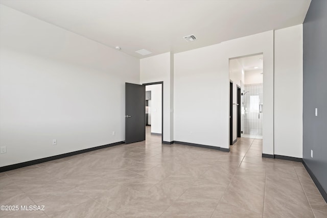 unfurnished room with light tile patterned floors, baseboards, and visible vents