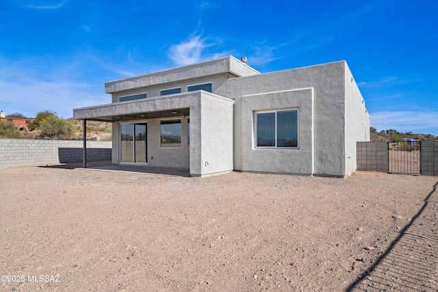 back of property with a patio area, fence, and stucco siding