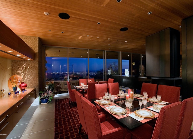 dining space featuring wooden ceiling, tile floors, and a wall of windows