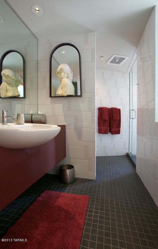 bathroom with tile walls, tile floors, and sink