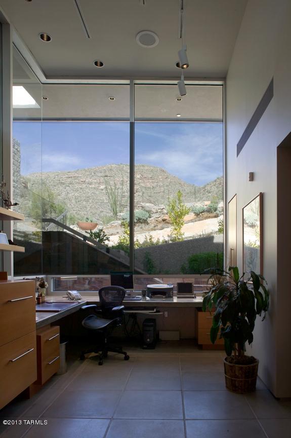 tiled office featuring a wall of windows and a mountain view