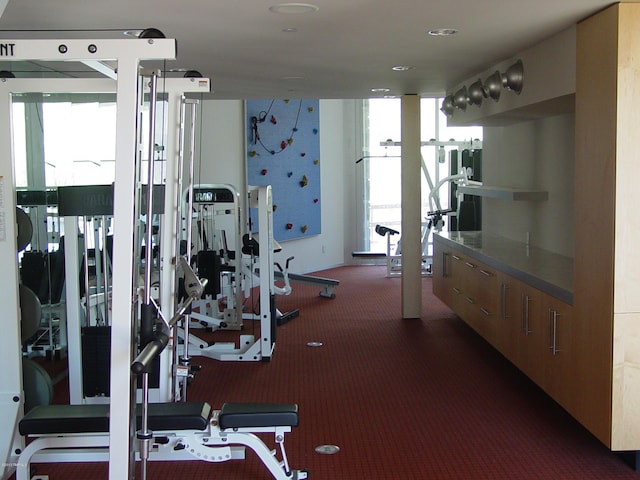 workout area with dark colored carpet