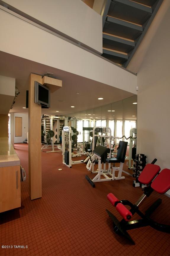 exercise room featuring a high ceiling and carpet