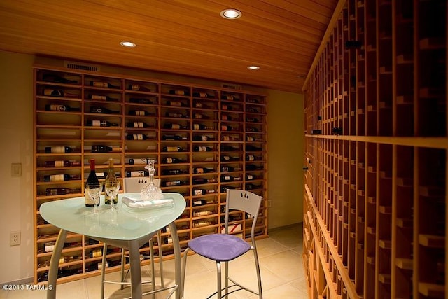 wine room featuring light tile floors and wood ceiling