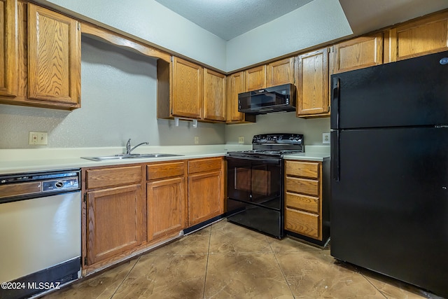 kitchen featuring a textured ceiling, black appliances, and sink