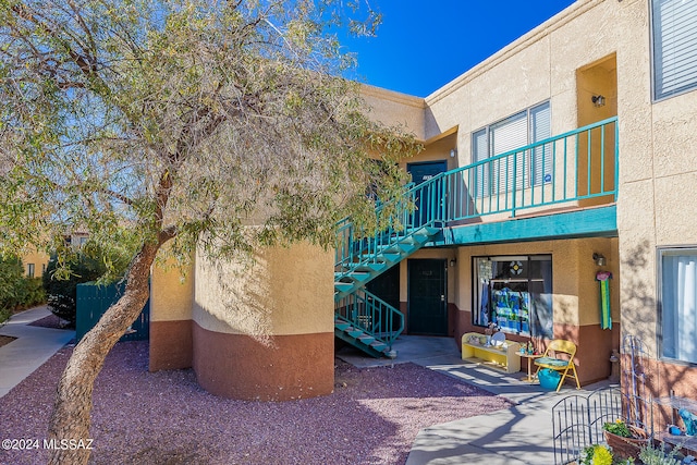 rear view of property with a balcony