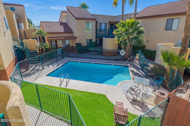 view of pool featuring a yard and a patio area