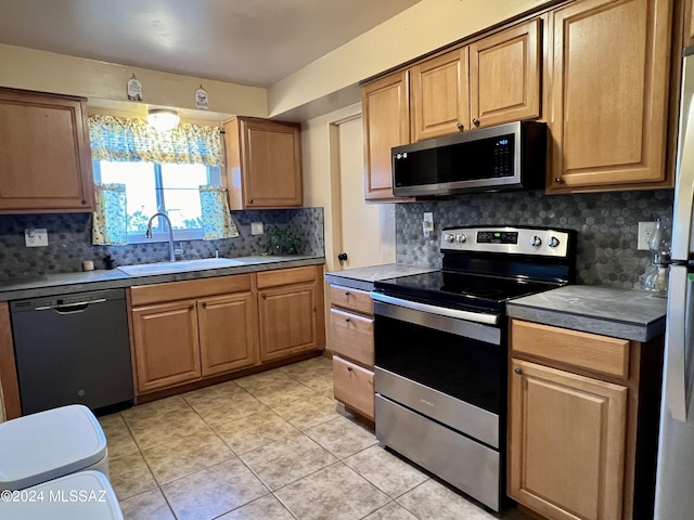 kitchen featuring stainless steel appliances, sink, and decorative backsplash