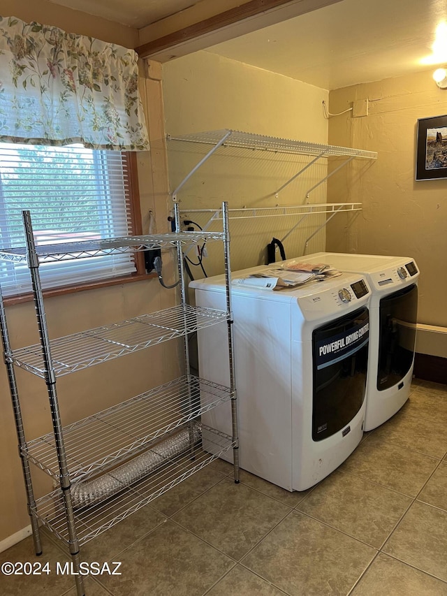 laundry area featuring tile patterned floors and washer and clothes dryer