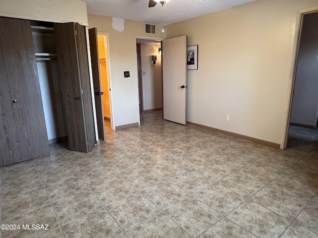 unfurnished bedroom featuring a closet and ceiling fan