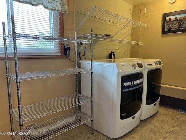 laundry area featuring tile patterned flooring and separate washer and dryer