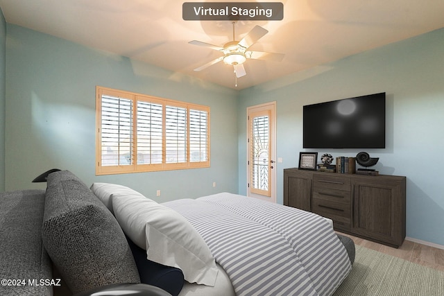 bedroom with access to exterior, light wood-type flooring, and ceiling fan