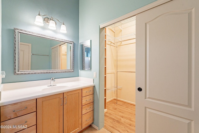 bathroom with hardwood / wood-style floors and vanity