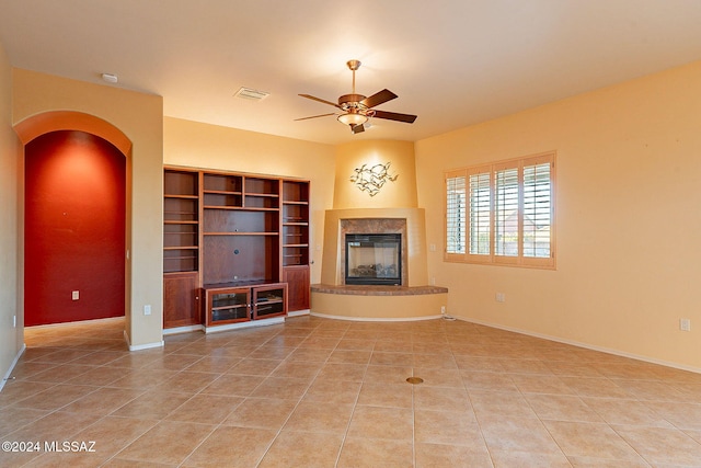 unfurnished living room featuring ceiling fan and light tile patterned flooring