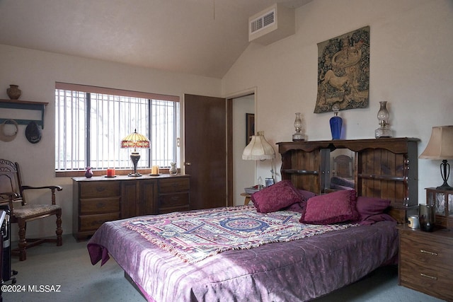 bedroom with vaulted ceiling and light colored carpet