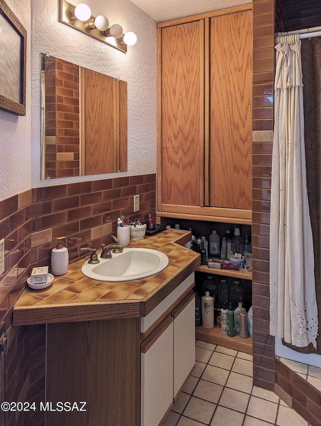 bathroom featuring tasteful backsplash, vanity, and tile patterned floors