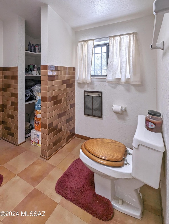 bathroom featuring toilet and a textured ceiling