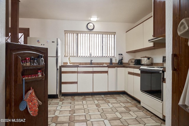 kitchen featuring white cabinetry, white electric range oven, and sink