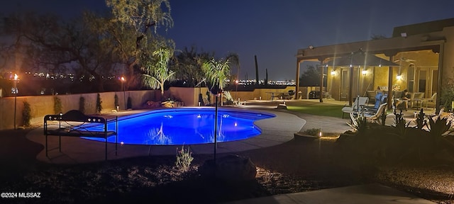 pool at night with a patio