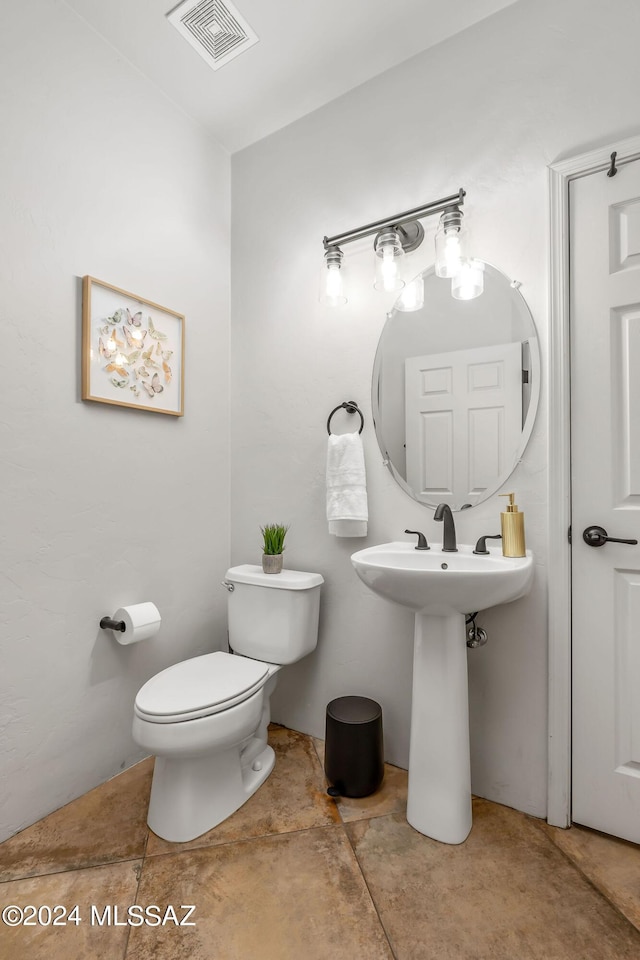 bathroom with toilet and sink