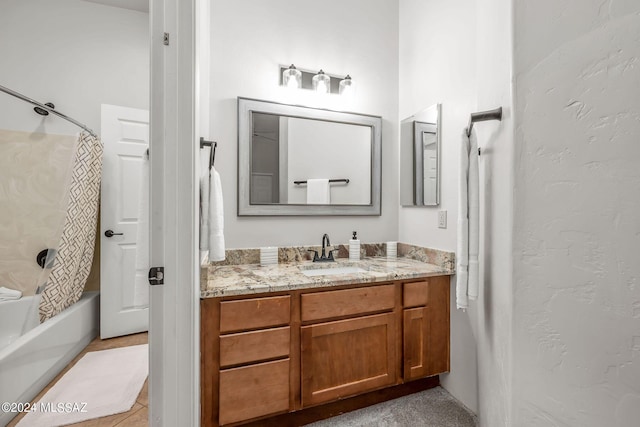 bathroom featuring tile patterned flooring, shower / bath combo, and vanity