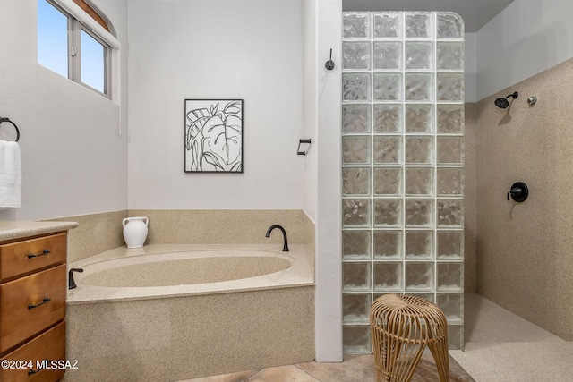 bathroom with tile patterned floors and shower with separate bathtub