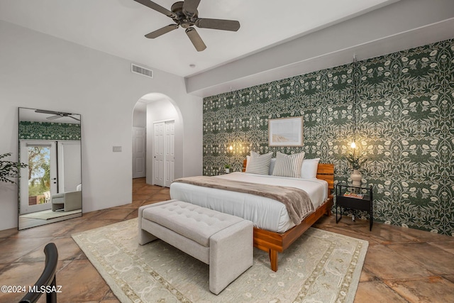 bedroom featuring ceiling fan, french doors, and a closet