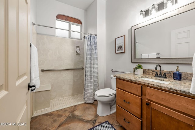 bathroom featuring toilet, vanity, and walk in shower