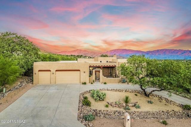 southwest-style home featuring a mountain view and a garage