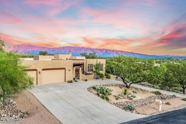 view of front of home featuring a mountain view and a garage