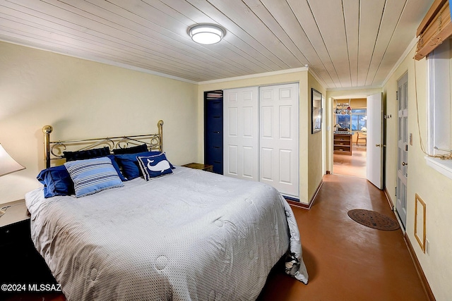 bedroom featuring wood ceiling, crown molding, and a closet