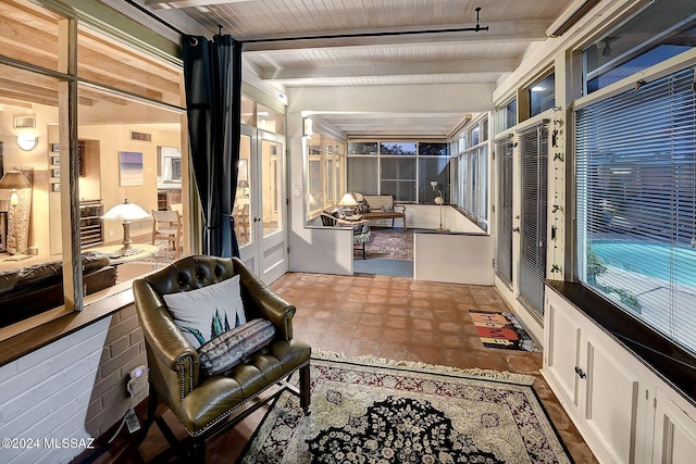 sunroom with wood ceiling and beam ceiling