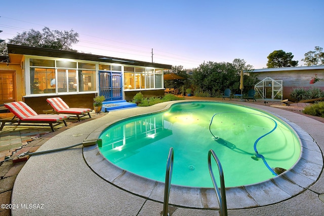 view of pool at dusk