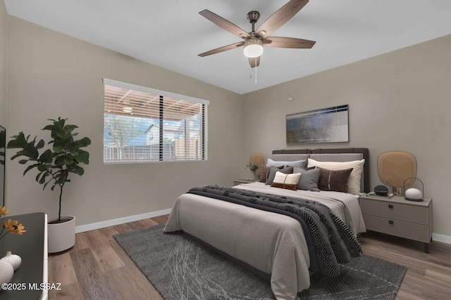 bedroom with hardwood / wood-style floors and ceiling fan