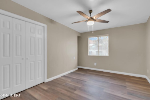 unfurnished bedroom featuring ceiling fan, wood-type flooring, and a closet