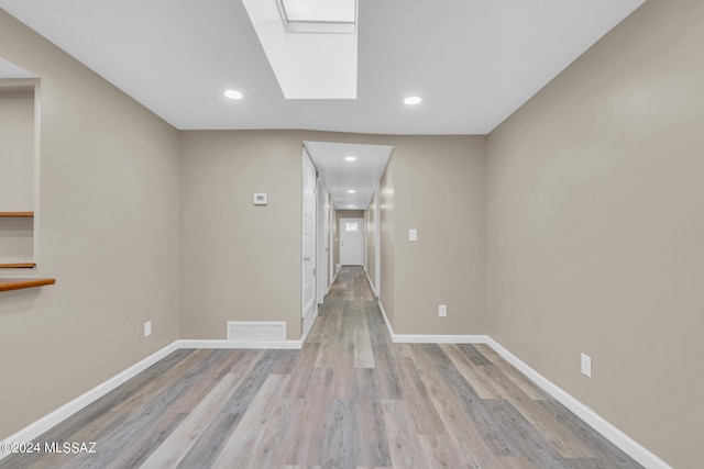 hallway with light hardwood / wood-style flooring